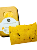 Orange color soap with flecks of oats, and carrots in front of sustainable box with white label reading Bubbly Moon Naturals Artisan Soap Bar No. 4 and words ayurvedic, illipe and a photo of turmeric root on the lable