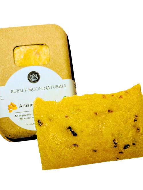 Orange color soap with flecks of oats, and carrots in front of sustainable box with white label reading Bubbly Moon Naturals Artisan Soap Bar No. 4 and words ayurvedic, illipe and a photo of turmeric root on the lable
